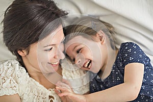 Mother playing with her baby in the bedroom