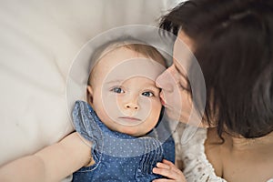 Mother playing with her baby in the bedroom