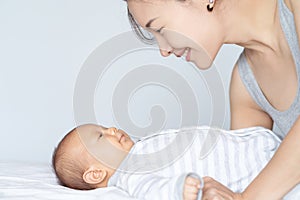 mother playing with her baby in the bedroom