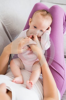 Mother playing with her baby in bedroom