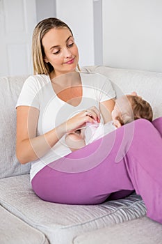 Mother playing with her baby in bedroom