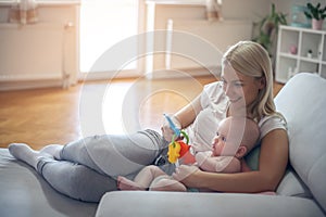 Mother playing with her baby boy at home.