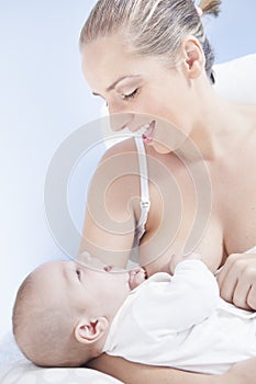 Mother playing with her baby after feeding breast