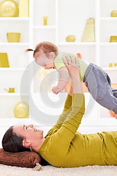 Mother playing with her baby girl photo