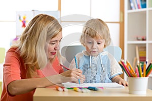 Mother playing with her child son, drawing together