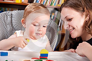 Mother playing with her son in blocks