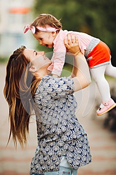 Mother playing with little daughter and throwing up.