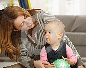 Mother playing with little girl