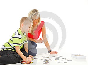 Mother playing puzzle together with her son