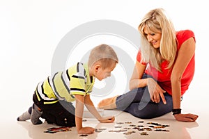 Mother playing puzzle toy with her son