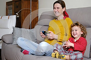 Mother playing video game with her son