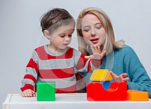 Mother plays with her son in dice