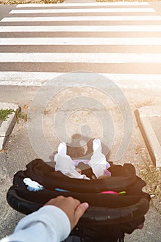 Mother POV view on the stroller and crossing road zebra. Safety with children on the road