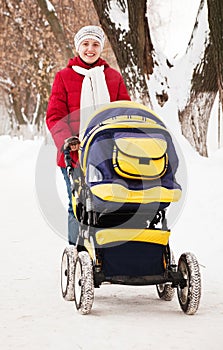 Mother with pram in winter park