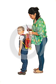 Mother prepare boy for school photo