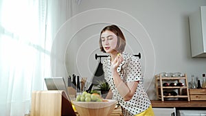 Mother prepare food for making salad while looking at food recipe. Pedagogy.