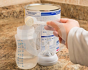 Mother preparing baby formula