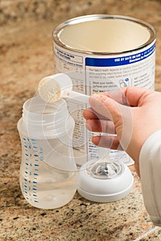Mother preparing baby formula