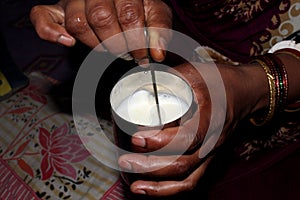 Mother preparing milk for her baby at home in traditional style