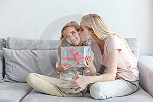mother presenting birthday gift for daughter