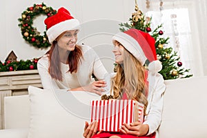 Mother presenting christmas gift for daughter