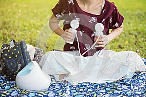 Mother pumping breastmilk in park