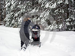 Mother Pushing Stroller in Deep Snow