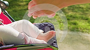 Mother Putting Socks on Baby`s Feet