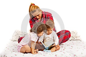 Mother reading a bedtime story to her kids