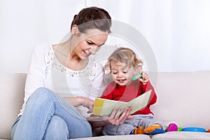 Mother reading book with child