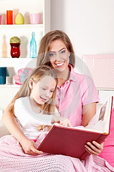 Mother reading book with child