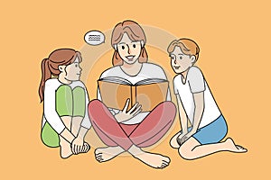 Mother reading book with children