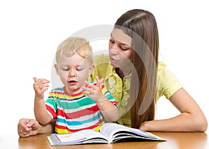 Mother reading a book to child boy