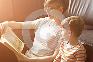 Mother reading the book to the child