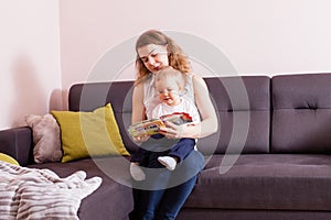 Mother reading book to her baby boy