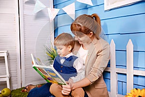 Mother reading a book to her little boy. Mom is reading bedtime story