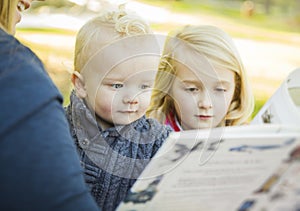 Mother Reading a Book to Her Two Adorable Blonde Children