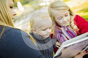 Mother Reading a Book to Her Two Adorable Blonde Children