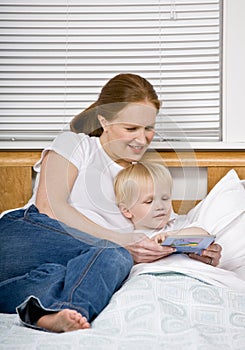 Mother reading son a bedtime story in bed