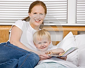 Mother reading son a bedtime story in bed