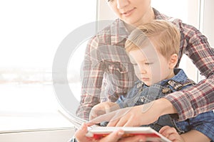 Mother reading to her child an interesting story