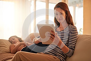 Mother, relax and tablet on sofa with young girl for streaming, social media and online games for enjoyment. Daughter