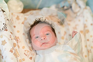 Mother rubs baby after bathing. the boy smiles and feels happy after taking a bath. mother dries and rubs the hair of the newborn