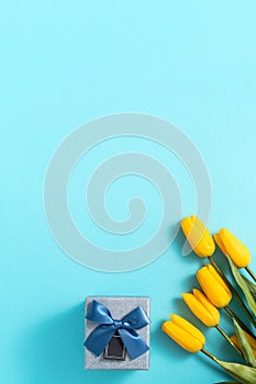 Mother`s day background concept. Top view design of holiday greeting tulip flower bouquet on bright blue table background