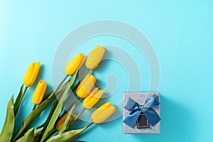 Mother`s day background concept. Top view design of holiday greeting tulip flower bouquet on bright blue table background