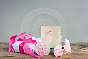 Mother`s Day background, gift box, three pink carnations