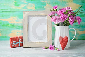 Mother`s day background with photo frame, flowers, heart shape and gift box