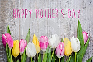 Mother`s Day Card. Colorful tulips on wooden background. Spring Easter Holiday Concept