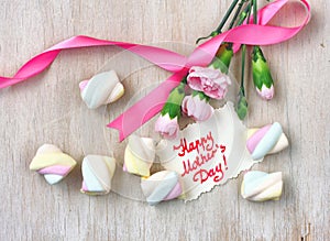 Mother`s day card, pink carnations and marshmallows