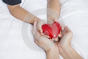 Mother`s Day celebration with woman holds young kid`s hands supp